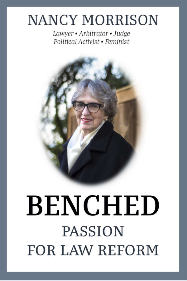 Book cover for Benched: Passion for Law Reform by Nancy Morrison. The cover shows a photo of Nancy in the centre, smiling and wearing large tortoiseshell glasses, a black coat and a beige scarf.
